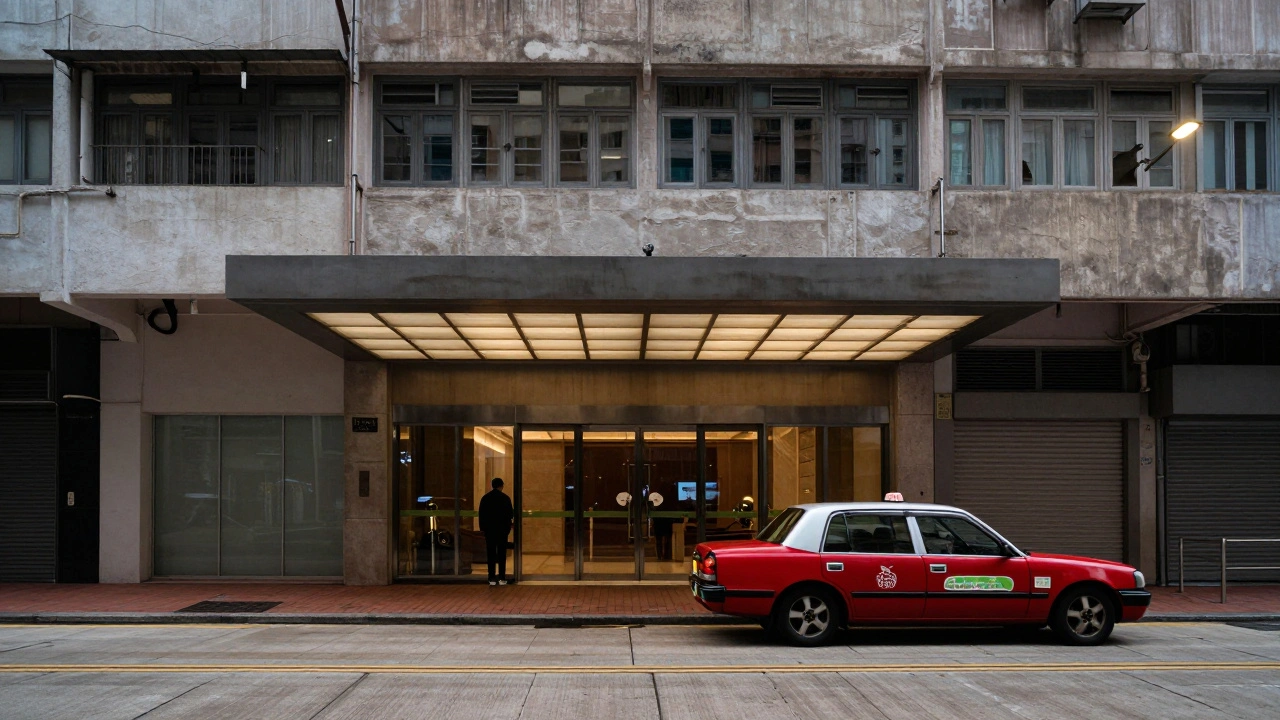 A red taxi departing from the entrance of a commercial building in Hong Kong.